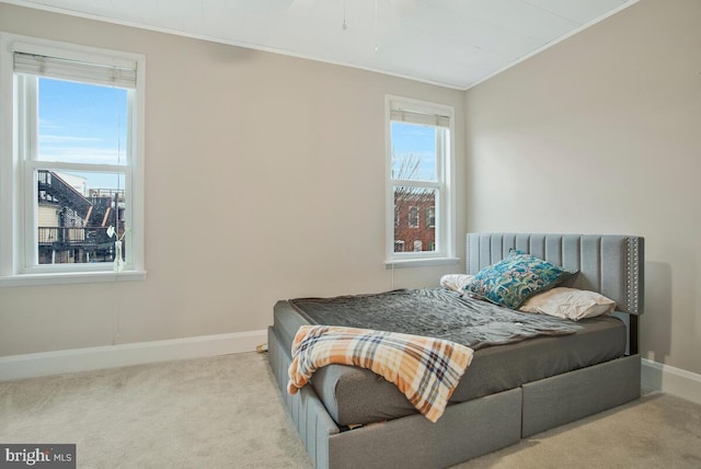 bedroom featuring crown molding and light colored carpet