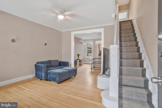 interior space featuring hardwood / wood-style floors, ornamental molding, and ceiling fan