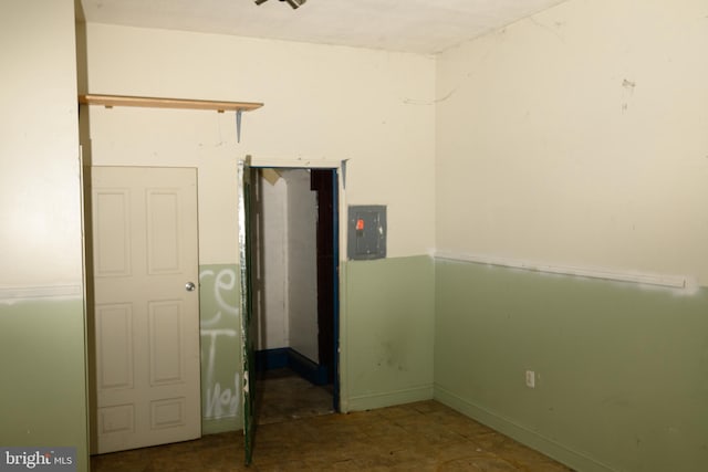 unfurnished room featuring electric panel