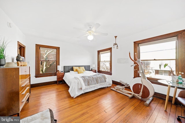 bedroom with ceiling fan and light hardwood / wood-style floors