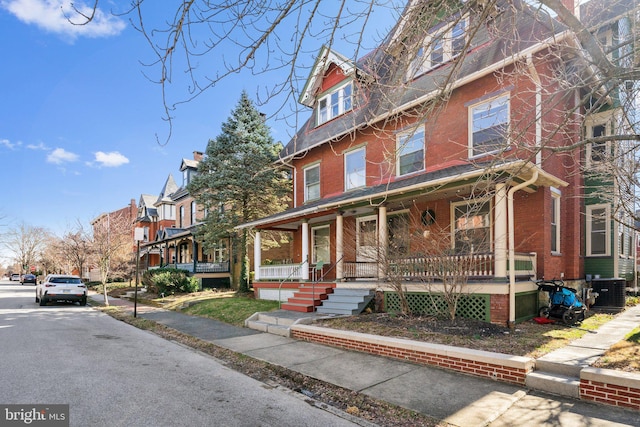 view of front of house with central AC and covered porch