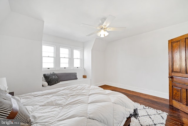 bedroom with dark hardwood / wood-style flooring and ceiling fan