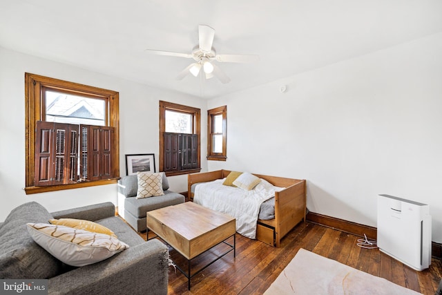 living room with dark wood-type flooring and ceiling fan