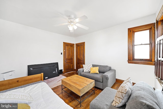 living room featuring hardwood / wood-style flooring and ceiling fan