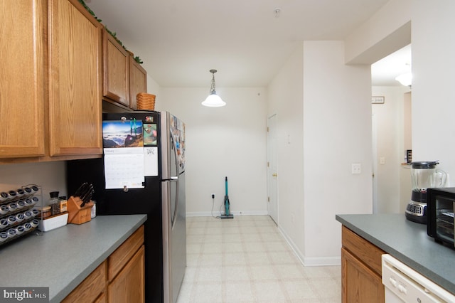 kitchen with pendant lighting, stainless steel fridge, and white dishwasher