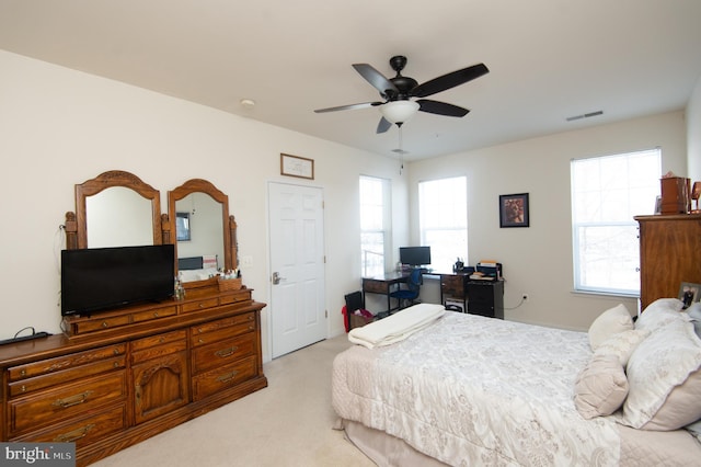 bedroom with light carpet and ceiling fan