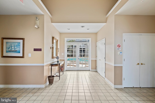 tiled foyer entrance with french doors