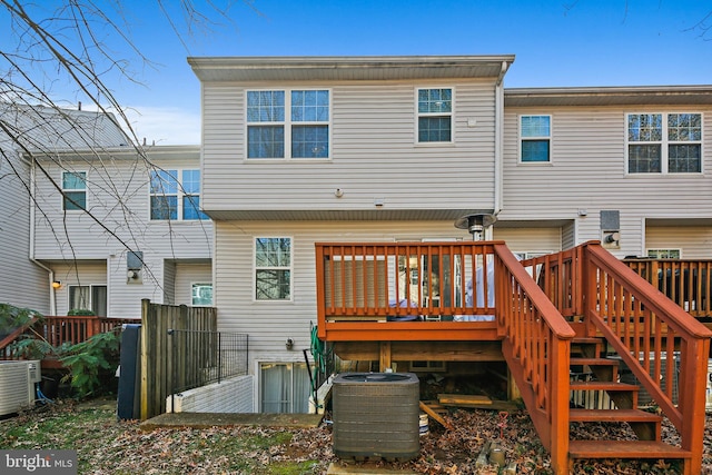 rear view of house with a wooden deck and central AC