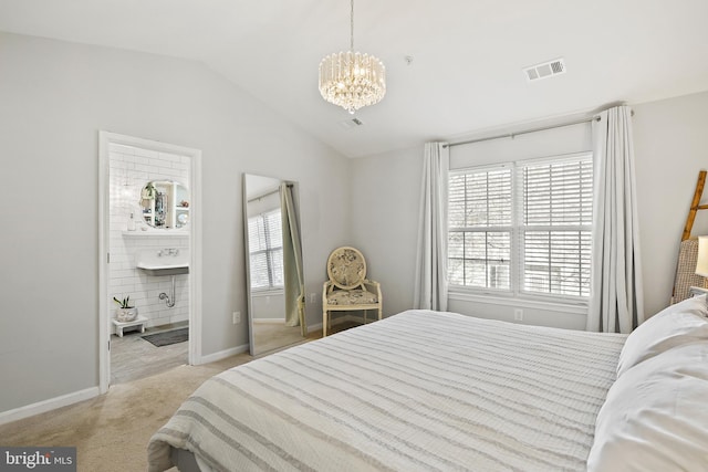 bedroom featuring sink, ensuite bath, a notable chandelier, vaulted ceiling, and light colored carpet