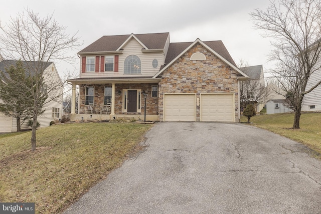 view of front of house featuring a garage, a front lawn, and a porch