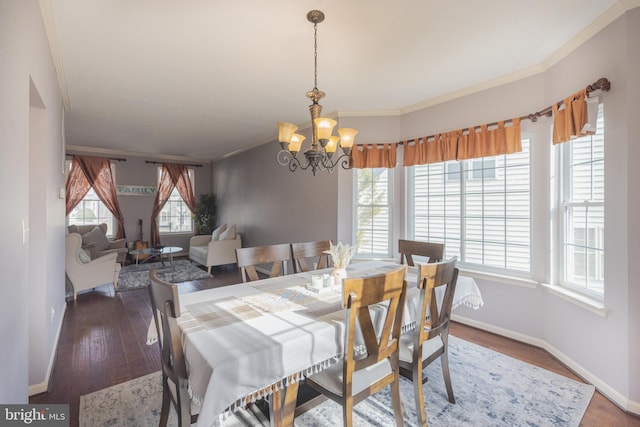 dining room featuring crown molding, a notable chandelier, plenty of natural light, and hardwood / wood-style flooring