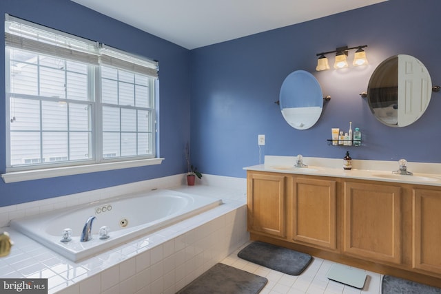 bathroom with vanity, tile patterned floors, and tiled bath