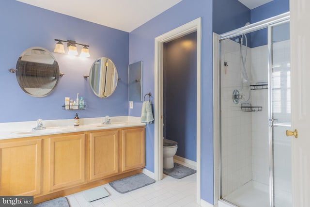 bathroom featuring an enclosed shower, vanity, and toilet