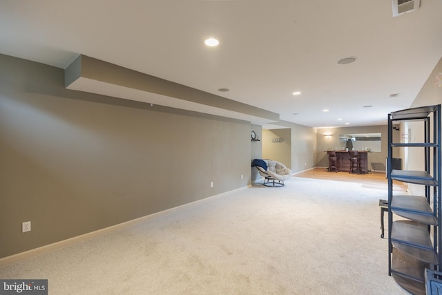 basement with bar and carpet floors