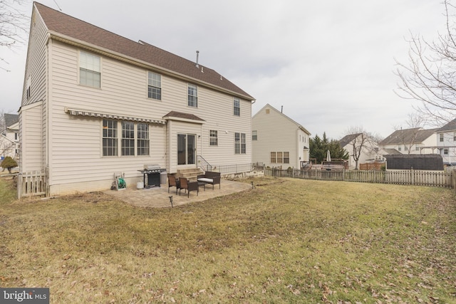 rear view of house with a patio and a yard