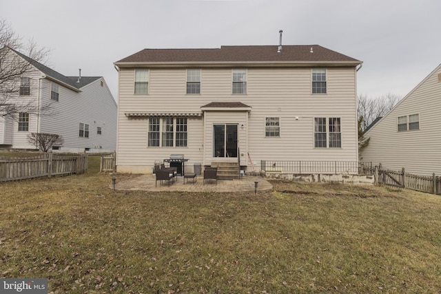 back of property featuring a patio area and a lawn