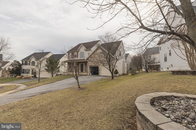 view of front of property with a garage and a front lawn