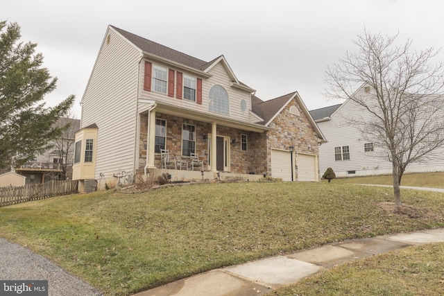 view of front facade with a garage, a front yard, and covered porch