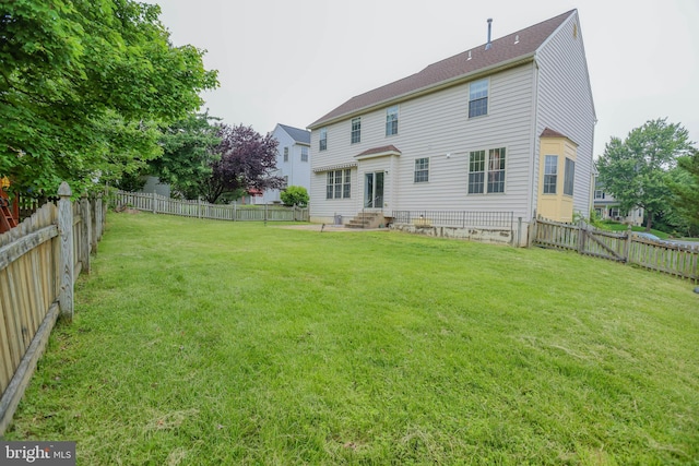 34 Broadbridge Rd, Rosedale, MD 21237 - rear view of house with entry steps and a fenced backyard