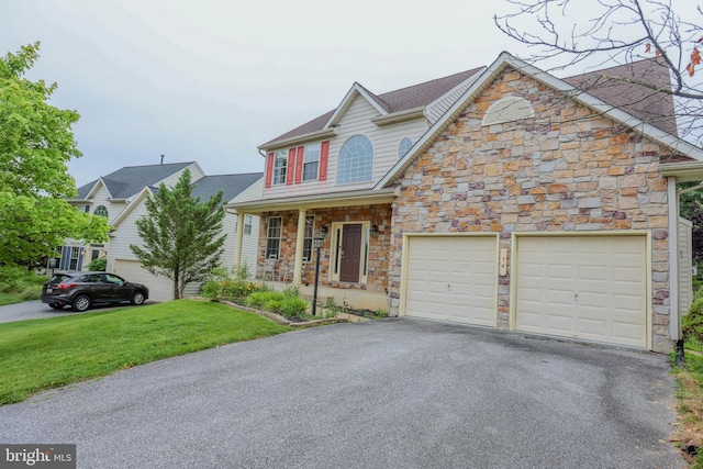 34 Broadbridge Rd, Rosedale, MD 21237 - view of front of property with stone siding, asphalt driveway, a front yard, and covered porch