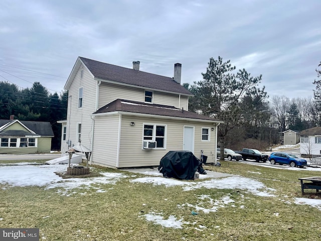 back of property featuring a yard and cooling unit