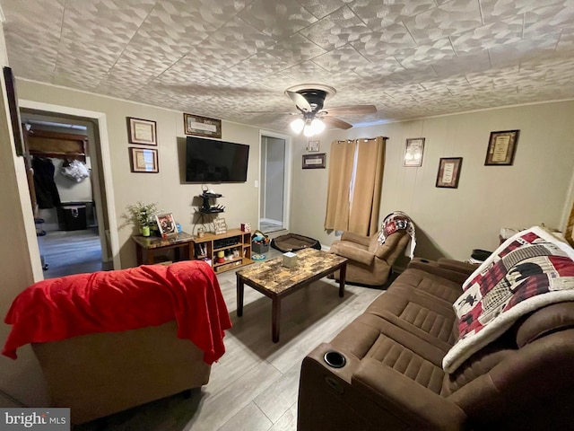 living room with ceiling fan and light wood-type flooring