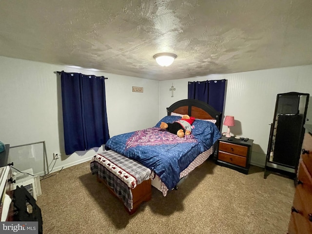 bedroom featuring carpet and a textured ceiling