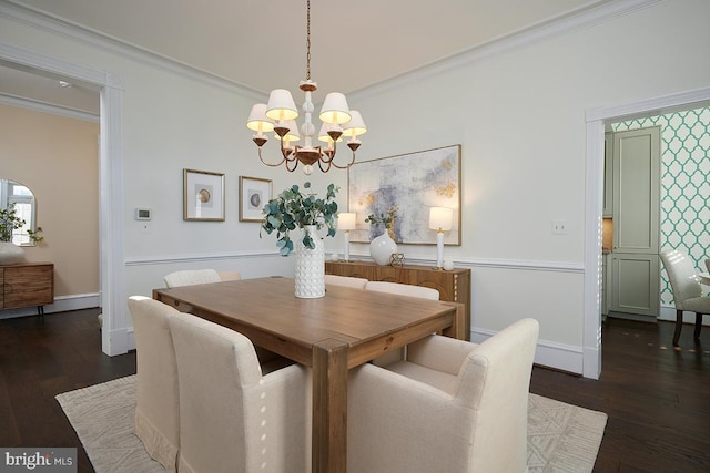 dining space with a chandelier, crown molding, and wood finished floors