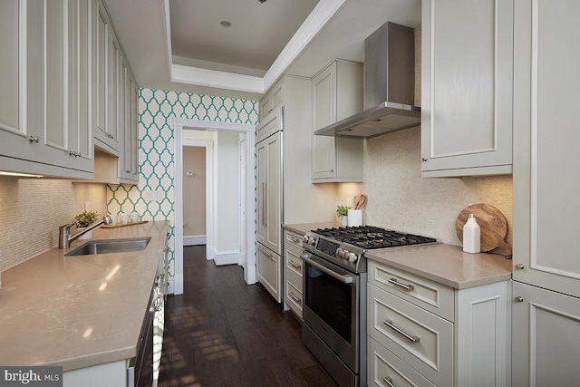 kitchen featuring sink, dark wood-type flooring, white cabinetry, gas range, and wall chimney exhaust hood