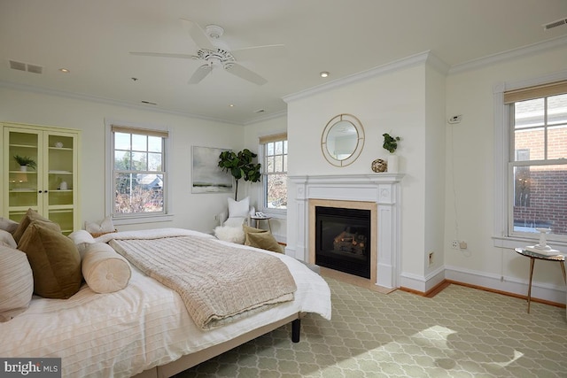 bedroom with multiple windows, crown molding, and ceiling fan