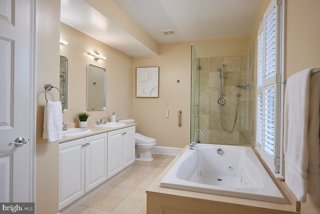 bathroom featuring toilet, a sink, tile patterned flooring, tiled shower, and a whirlpool tub