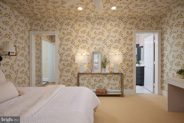 bedroom with wallpapered walls, ensuite bath, and carpet flooring