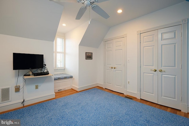 interior space featuring ceiling fan, wood-type flooring, and lofted ceiling