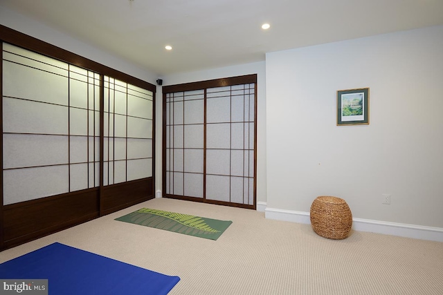 exercise area with carpet, baseboards, and recessed lighting