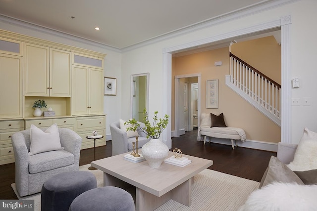 living room with dark hardwood / wood-style flooring and crown molding