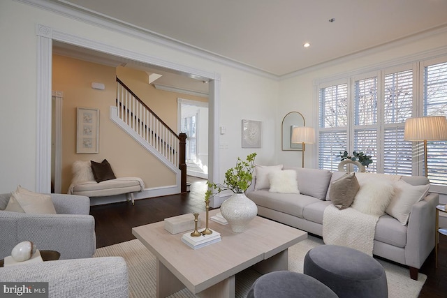 living room with ornamental molding, a healthy amount of sunlight, and dark hardwood / wood-style flooring