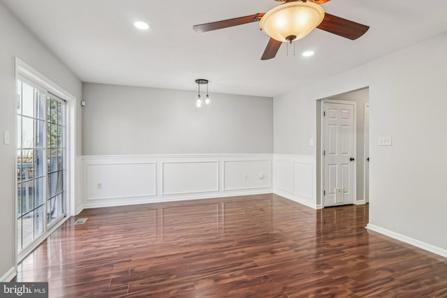 unfurnished room with ceiling fan and dark hardwood / wood-style flooring