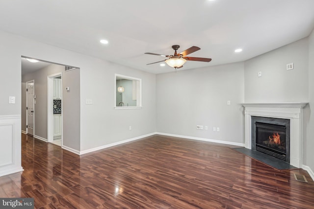 unfurnished living room with ceiling fan and dark hardwood / wood-style flooring