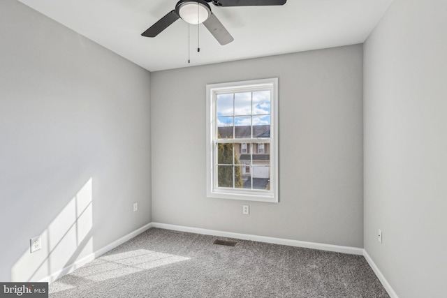 carpeted empty room featuring ceiling fan