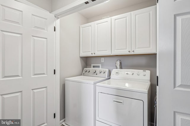 washroom with cabinets and separate washer and dryer