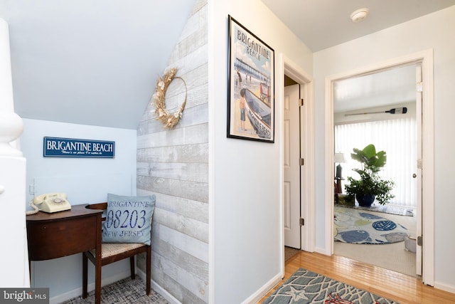 hallway with hardwood / wood-style flooring