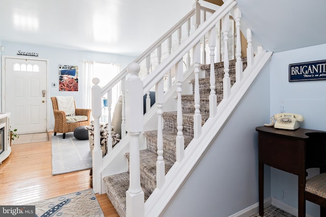 staircase with hardwood / wood-style flooring