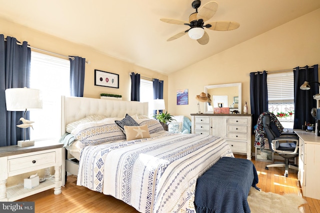 bedroom with lofted ceiling, ceiling fan, and light wood-type flooring