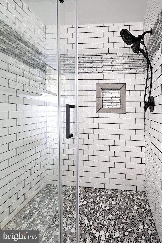 bathroom with a shower with shower door