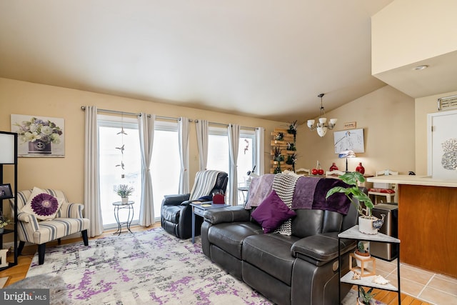 living room featuring lofted ceiling and a chandelier