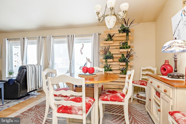 dining space with an inviting chandelier and hardwood / wood-style flooring