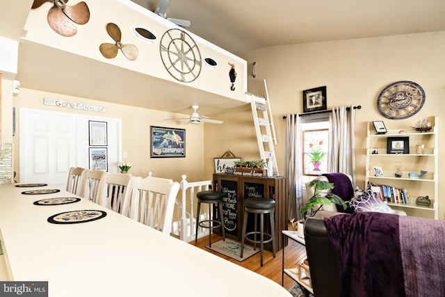 dining space with hardwood / wood-style flooring, vaulted ceiling, and ceiling fan