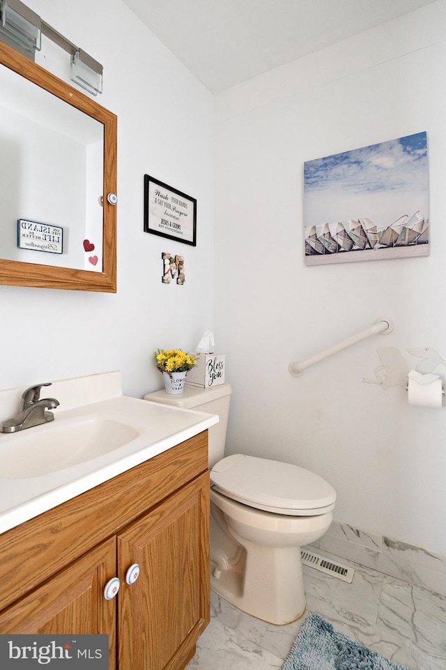 bathroom featuring vanity and toilet