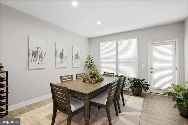 dining space with light wood-type flooring, baseboards, and recessed lighting