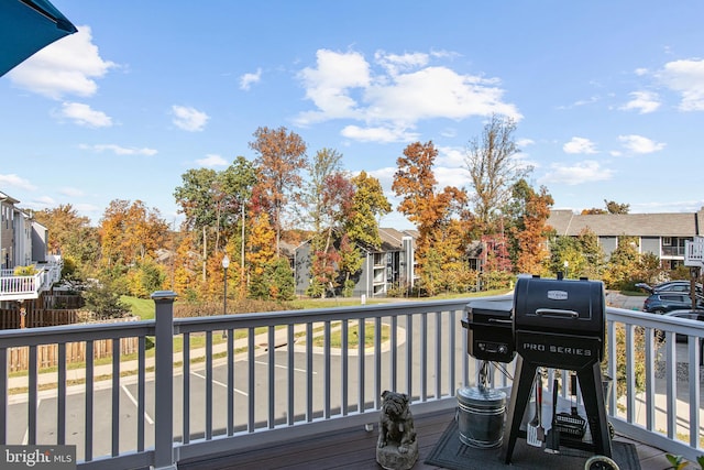 deck with a residential view and grilling area